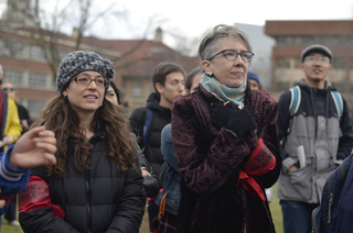 Jackie Orr (right) and 
Ivy Kleinbart (left) both stand in the cold on Wednesday afternoon for the Women’s Day Sanctuary Campus Rally.